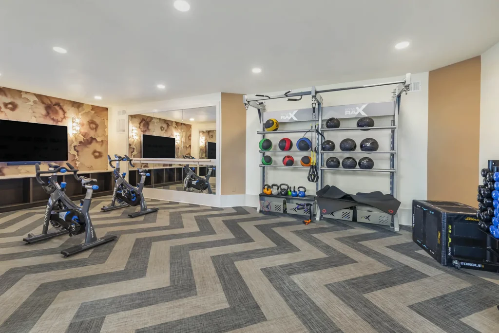 Fitness center with free weights, strength training machines, and cardio equipment