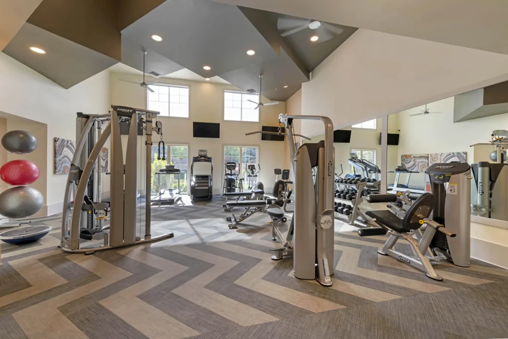 Fitness center with free weights, strength training machines, and cardio equipment
