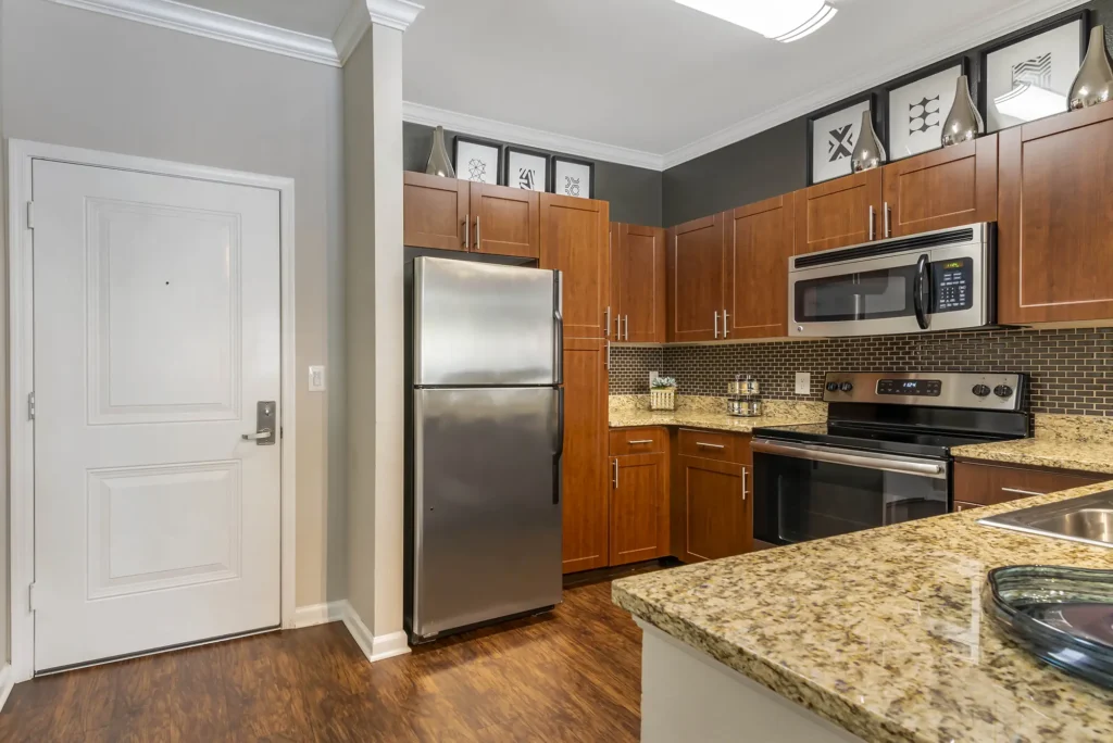 Kitchen with stainless steel appliances, granite counter tops, and tile back splash